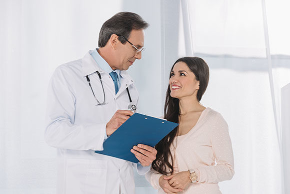 doctor going over a Business insurance for his dental practice in Coachella