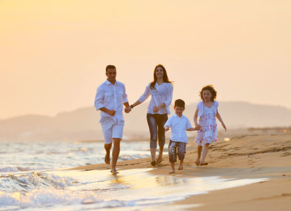 famly on the beach during sunset enjoying group life insurance in Palm Springs